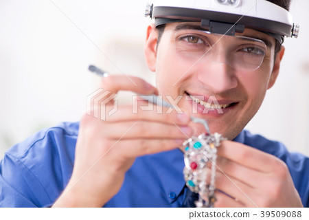 Jeweler working with luxury jewelry in the 39509088