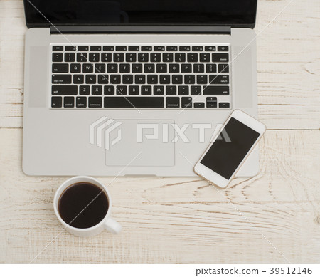 Laptop keyboard, phone and mug of coffee 39512146