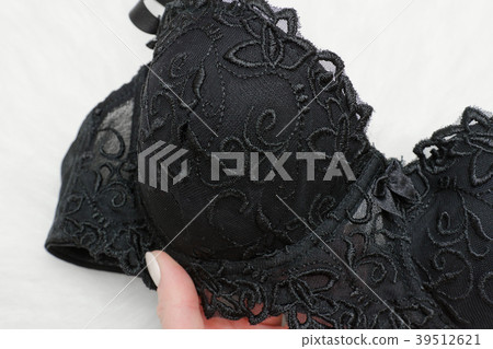 Part of black bra in female hand 39512621