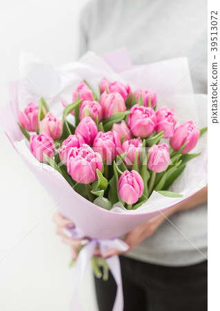 Tulips of pink color in woman hand. Big buds Tulips of pink color in woman hand. Big buds 39513072