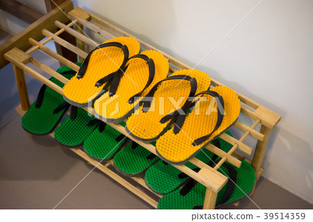 Shoe Rack with yellow and green rubber sandal Shoe Rack with yellow and green rubber sandal 39514359