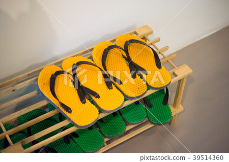 Shoe Rack with yellow and green rubber sandal Shoe Rack with yellow and green rubber sandal 39514360