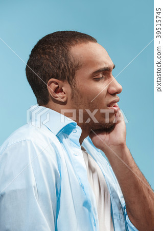 Sad Afro-American man is having toothache. against 39515745