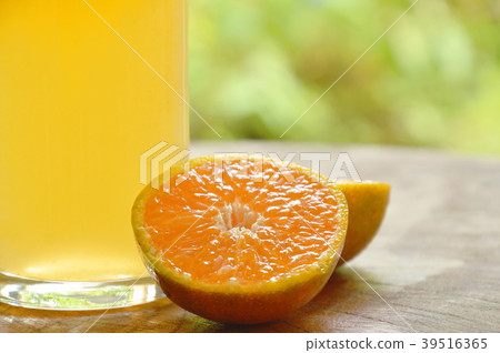 orange juice in glass and tangerine cutting orange juice in glass and tangerine cutting 39516365