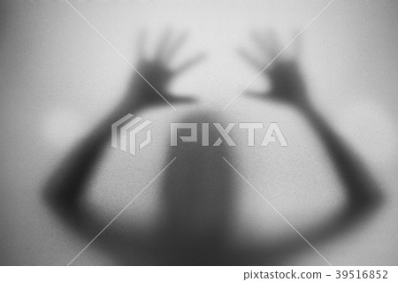 Shadow of woman on the white frosted glass 39516852