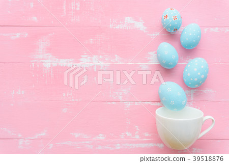 Row colorful Easter eggs spread out from white cup 39518876