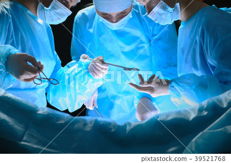 Group of surgeons at work in operating theater 39521768