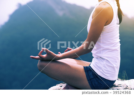 One fitness woman practicing yoga at mountain peak One fitness woman practicing yoga at mountain peak 39524368