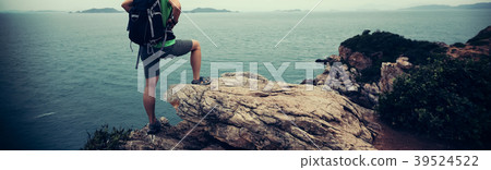 woman enjoy the view on seaside mountain top cliff woman enjoy the view on seaside mountain top cliff 39524522