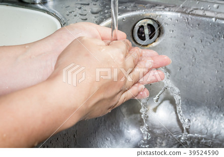 Woman washing hand under running Woman washing hand under running 39524590