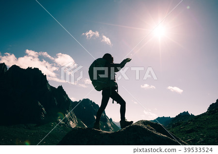 woman with backpack hiking on sunrise mountain top woman with backpack hiking on sunrise mountain top 39533524