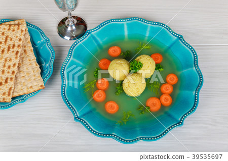 Matzah balls in a pot of soup during  39535697