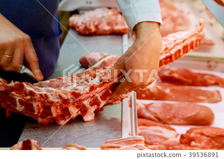 Butcher Preparing Meat In Shop 39536891
