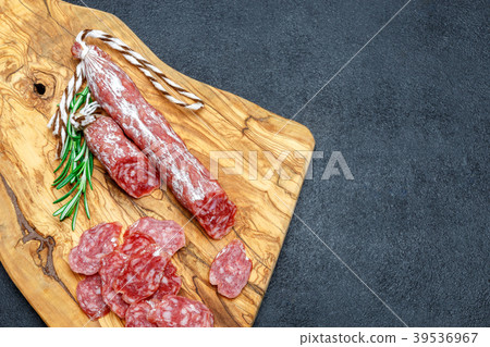 Dried organic salami sausage on wooden cutting Dried organic salami sausage on wooden cutting 39536967