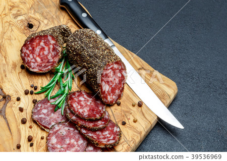 Dried organic salami sausage on wooden cutting 39536969