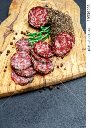 Dried organic salami sausage on wooden cutting Dried organic salami sausage on wooden cutting 39536993