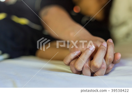 Hand sign orgasm of woman on white bed in hotel 39538422