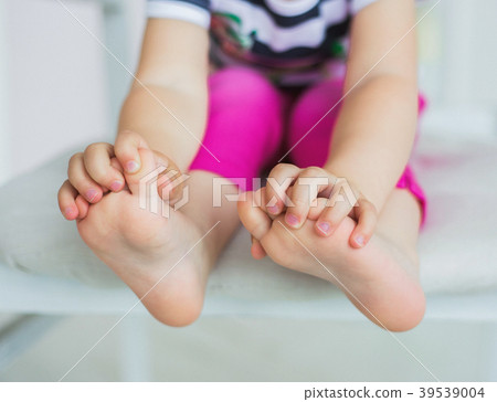Cute little baby girl sits on white chair  39539004