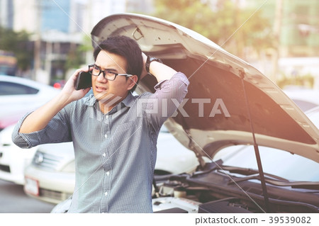Angry man stand in front a broken car calling Angry man stand in front a broken car calling 39539082