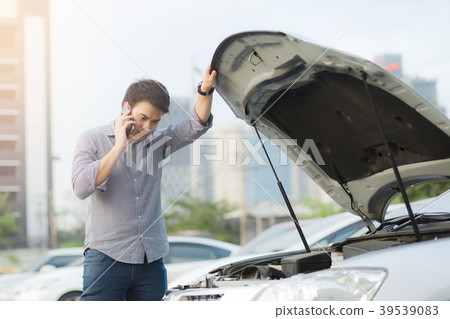 Angry man stand in front a broken car calling Angry man stand in front a broken car calling 39539083