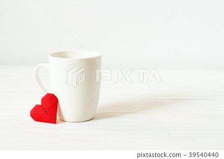 White cup and origami red heart with copy space 39540440