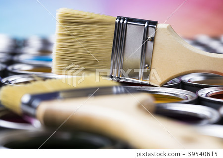 Paintbrush on cans with color 39540615