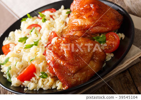 ruddy chicken thighs with a garnish of rice 39545104