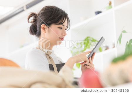 Female lifestyle tablet operation in the kitchen Female lifestyle tablet operation in the kitchen 39548196