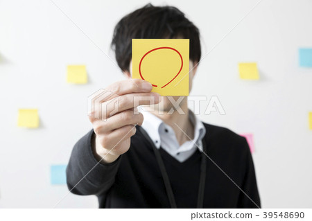 Young man giving out sticky notes Young man giving out sticky notes 39548690