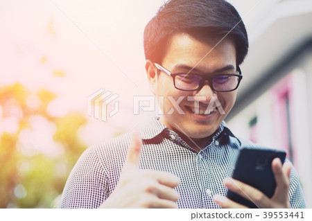 Handsome Business man in an using telephone glad 39553441