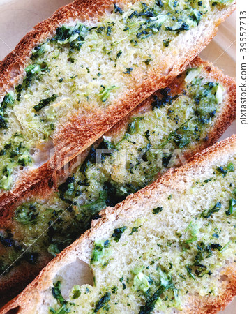 Toasts with basil and garlic close-up on a plate. 39557713