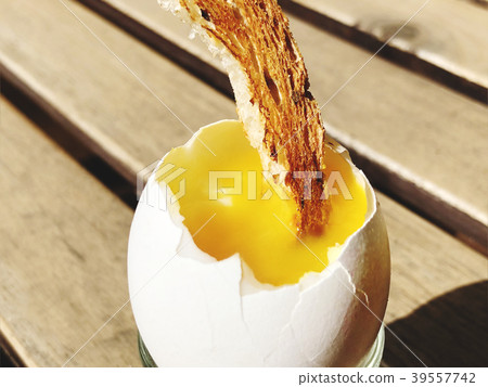 Soft boiled chicken egg with a piece of toast Soft boiled chicken egg with a piece of toast 39557742