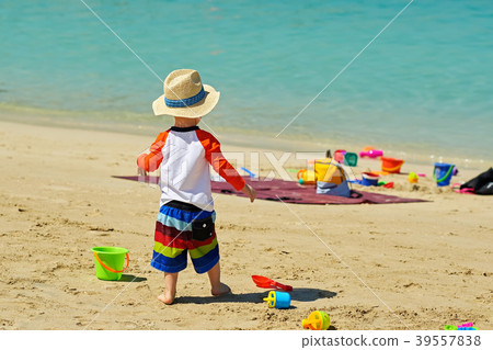 Two year old toddler playing on beach 39557838