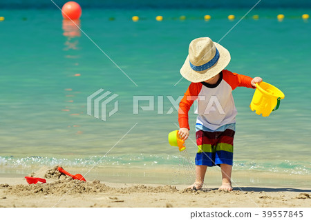 Two year old toddler playing on beach 39557845