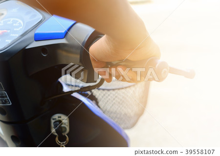 Selective focus of man's hand riding motorcycle 39558107