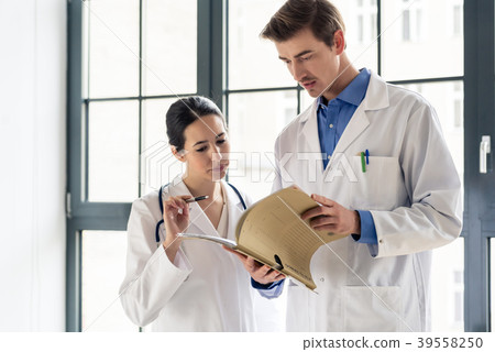 Two doctors checking together the medical record 39558250