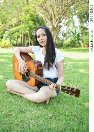Music Concepts. Asian girls playing guitar. Asian women relaxing 39558308
