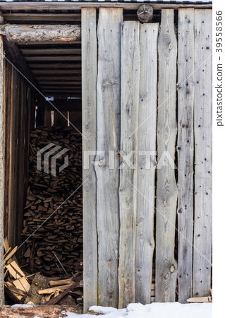 Village shed storing firewood for the winter Village shed storing firewood for the winter 39558566
