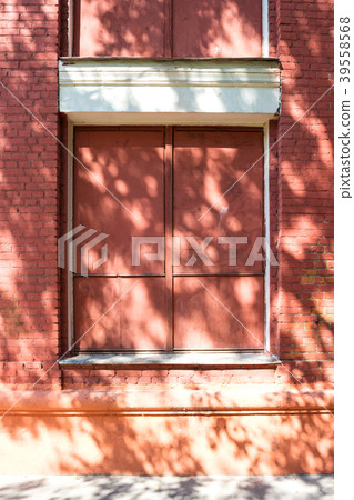 Metal-covered window in an old brick house Metal-covered window in an old brick house 39558568