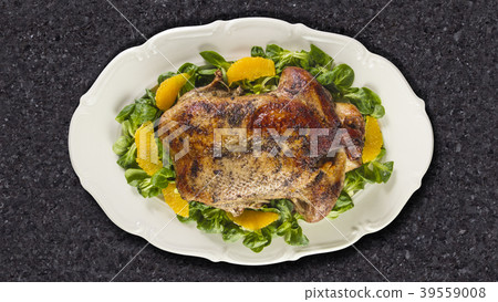 Baked duck in oranges and field salad 39559008