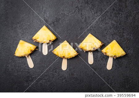 Ripe Pineapple slices on a black background 39559694