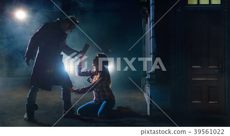 Murderer with knife and victim on night street 39561022