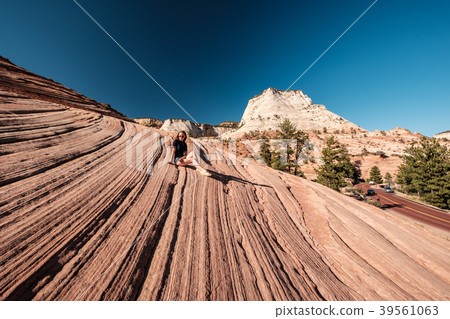 Woman sitting on rock formation in Utah, USA 39561063