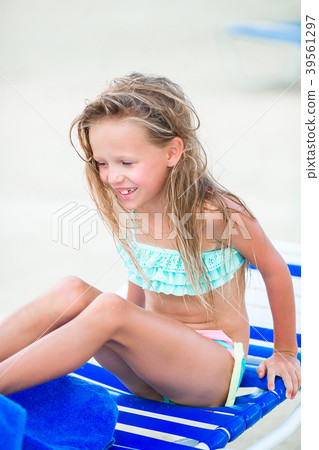 Little happy girl playing on the beach and having 39561297