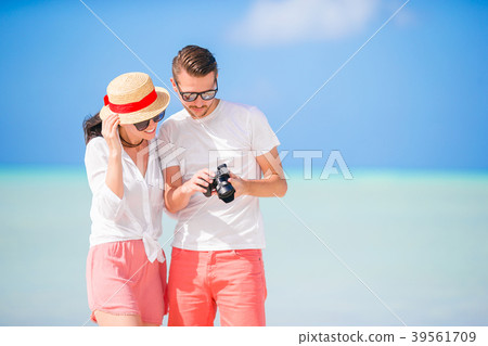Happy couple taking a selfie photo on white beach 39561709