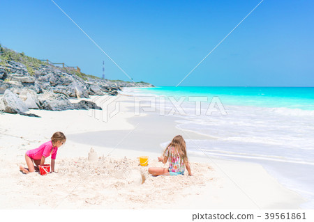 Adorable little kids play with sand on the white Adorable little kids play with sand on the white 39561861
