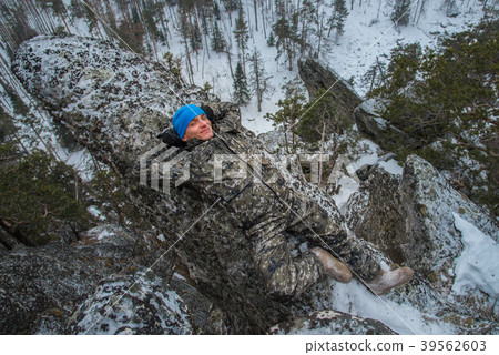 Man hiker have rest at mountain top, relax lying Man hiker have rest at mountain top, relax lying 39562603