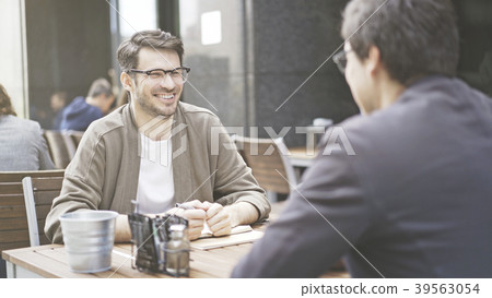 Two friends are laughing at table of the cafe Two friends are laughing at table of the cafe 39563054