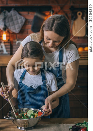 Mother and daughter mixing salad Mother and daughter mixing salad 39564859