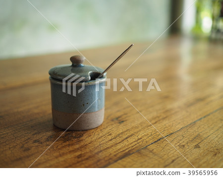 Sugar bowl celadon green ceramic on wood table Sugar bowl celadon green ceramic on wood table 39565956